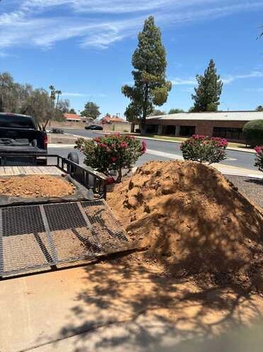 Soil and debris beside Arizona desert landscaping