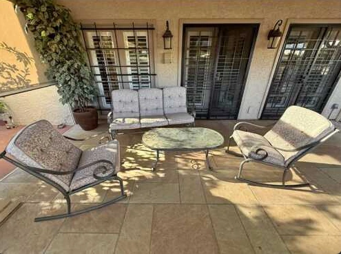Outdoor chairs and a table on a tiled patio