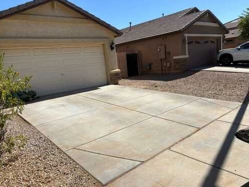 Clean driveway beside an Arizona stucco home